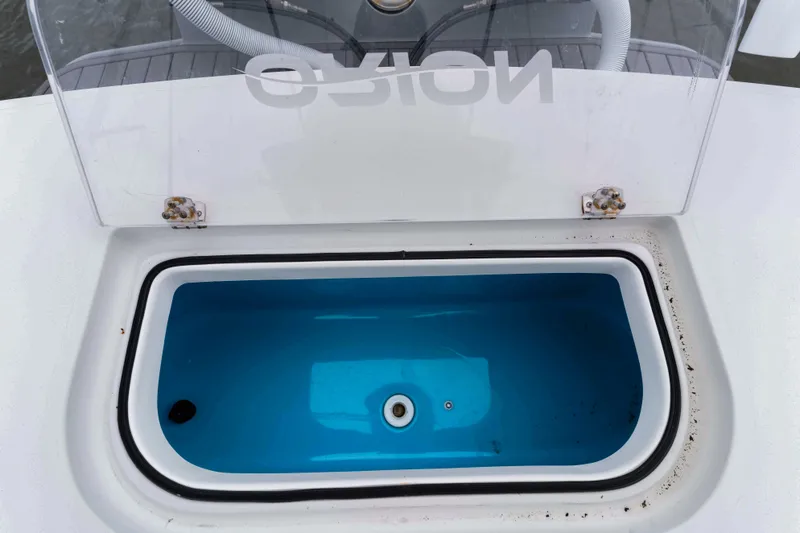 Slide: The Image of Open livewell on Orion 29 boat, 2025 model, with clear lid and blue interior. - 13