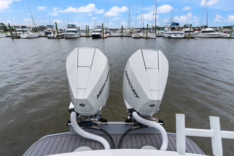Slide: The Image of Twin Mercury outboard engines on Orion 29 boat, docked in a marina, 2025 model. - 4