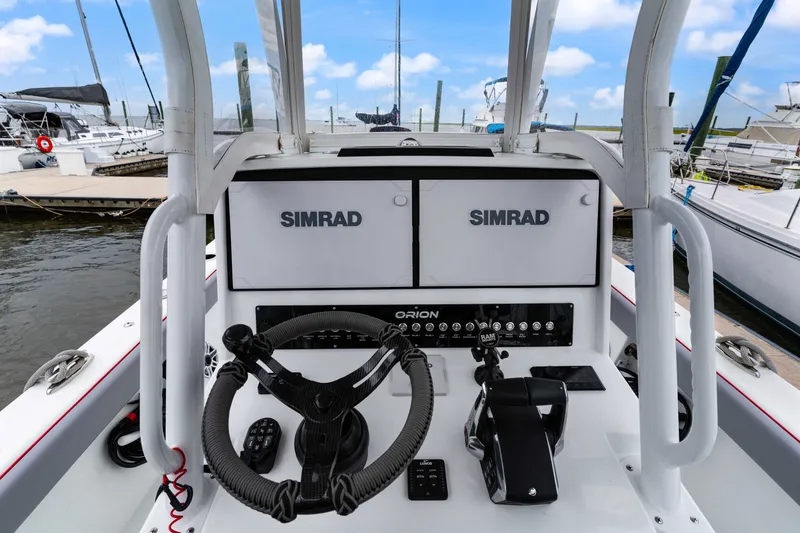 Slide: The Image of Control panel of 2025 Orion 29 boat with Simrad navigation system at marina. - 6
