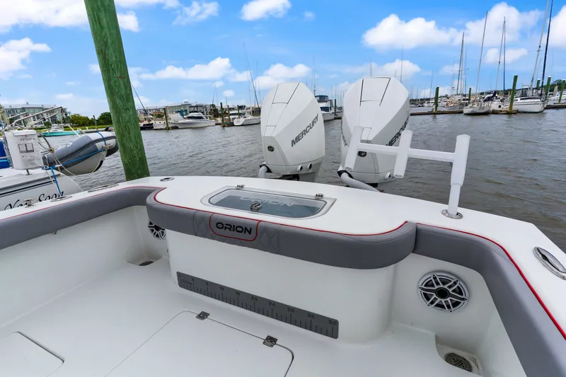 Slide: The Image of Orion 29 boat with dual Mercury engines docked at a marina, 2025 model. - 12