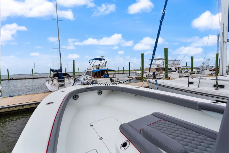 Slide: The Image of Modern Orion 29 boat docked at marina, clear blue sky, 2025 model. - 8