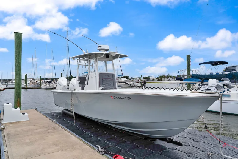 The Image of 2025 Orion 29 boat docked at marina under blue sky. - 0