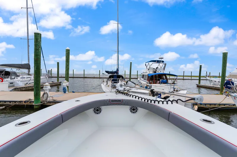 Slide: The Image of Orion 29 boat docked at marina, clear blue sky, 2025 model. - 7