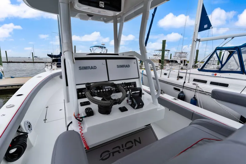 Slide: The Image of Modern Orion 29 boat cockpit with Simrad navigation, docked at marina, 2025 model. - 5