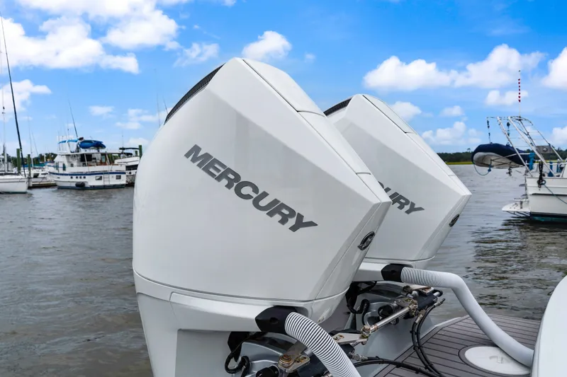 Slide: The Image of Twin Mercury outboard engines on a 2025 Orion 29 boat, docked at a marina. - 11