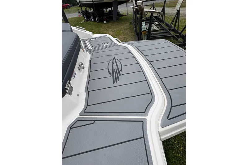Slide: The Image of 2021 Chaparral 21 SSi boat deck with gray non-slip surface and logo. - 13