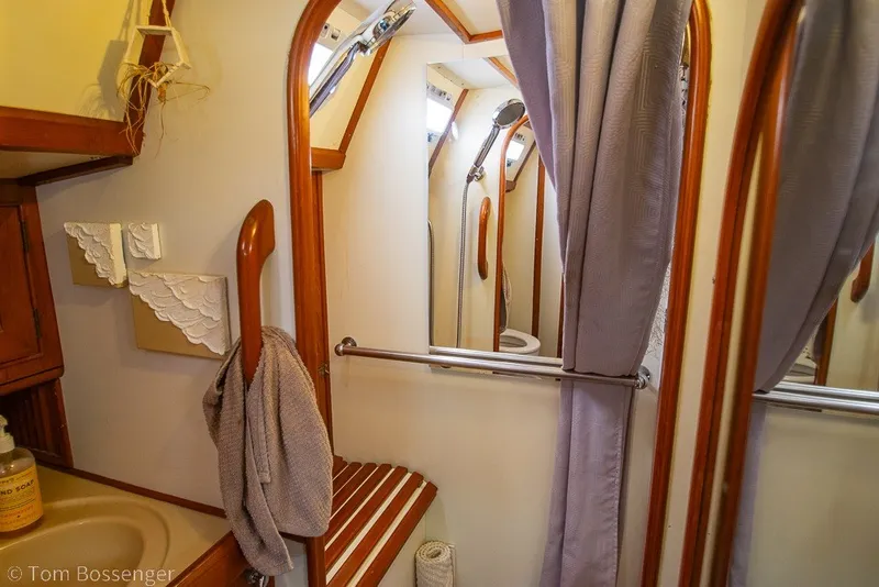 Slide: The Image of Interior of 1988 Hylas 44 Center Cockpit yacht bathroom with wooden accents and shower. - 25