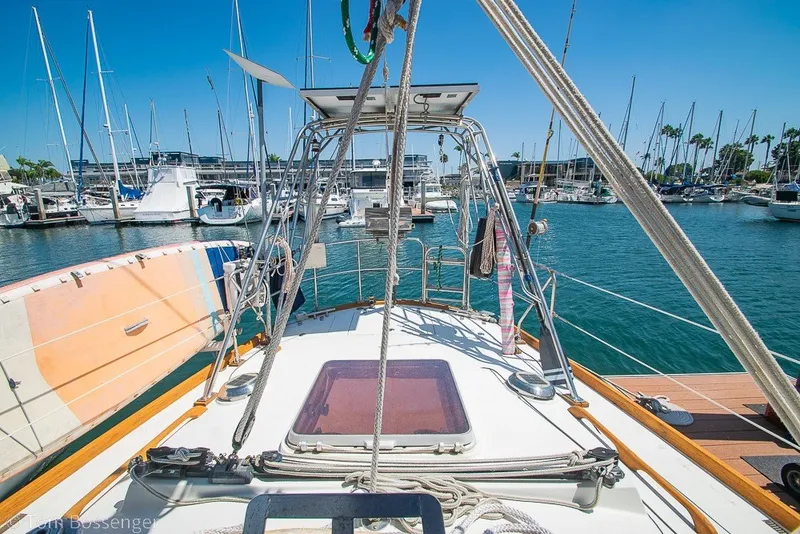Slide: The Image of Sailboat deck view of 1988 Hylas 44 Center Cockpit in marina setting. - 50
