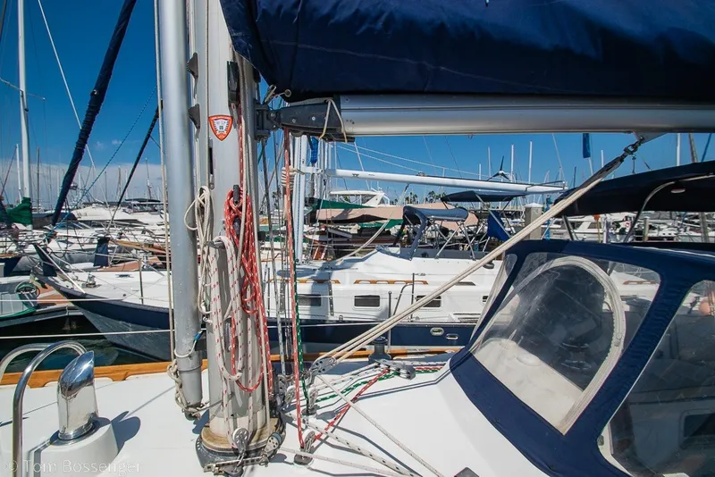 Slide: The Image of 1988 Hylas 44 Center Cockpit sailboat docked in a marina, surrounded by other boats. - 65