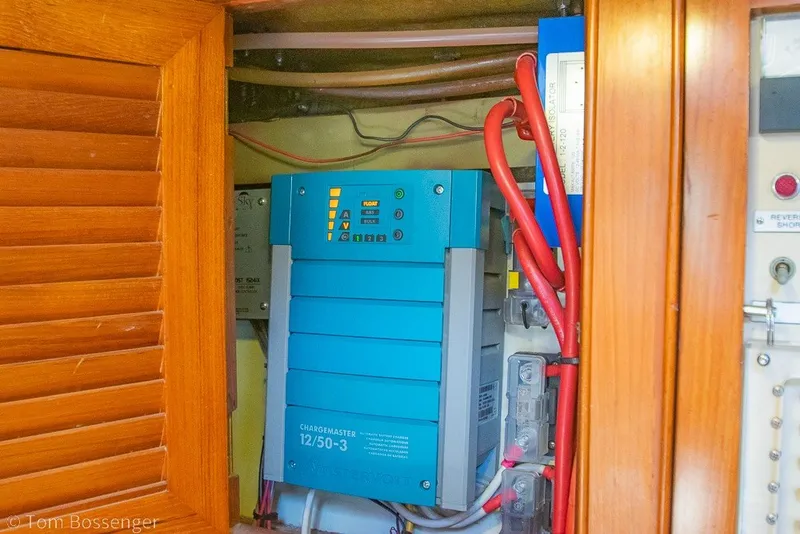 Slide: The Image of Electrical panel inside 1988 Hylas 44 Center Cockpit yacht, featuring a blue battery charger. - 39