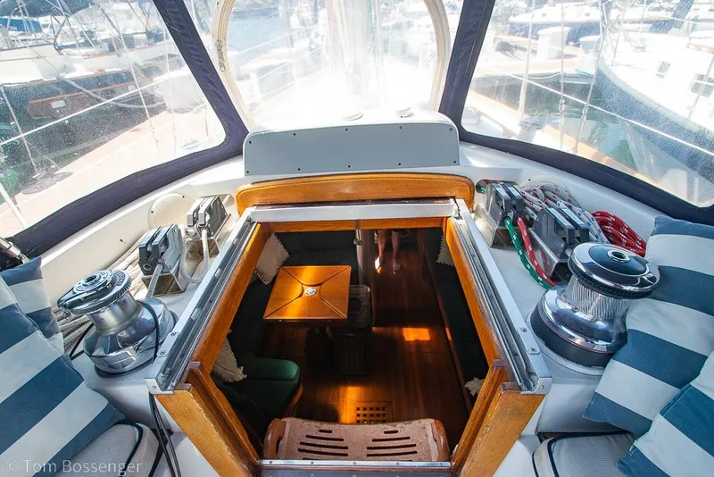 Slide: The Image of Cockpit view of 1988 Hylas 44 Center Cockpit sailboat with winches and striped cushions. - 60