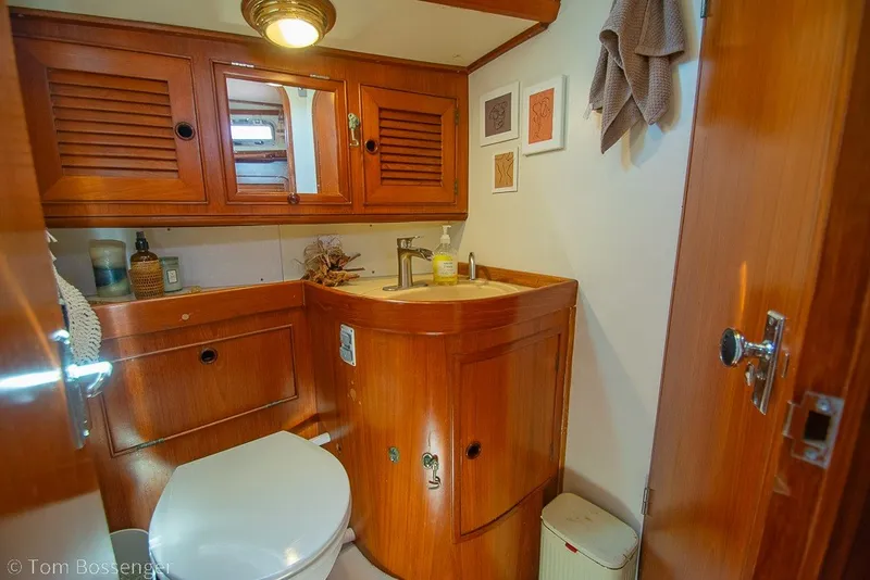 Slide: The Image of Wood-paneled bathroom in 1988 Hylas 44 Center Cockpit yacht, featuring sink and toilet. - 32