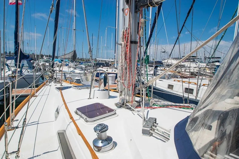 Slide: The Image of 1988 Hylas 44 Center Cockpit sailboat docked in a marina under clear blue skies. - 64