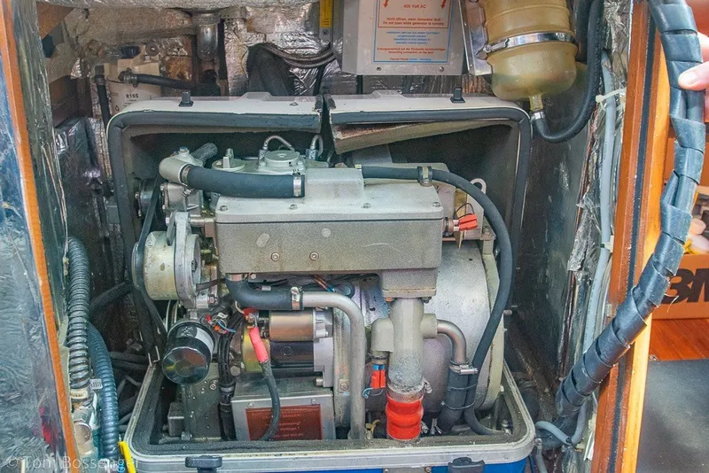 Slide: The Image of Engine compartment of a 1988 Hylas 44 Center Cockpit sailboat, showcasing mechanical components. - 85