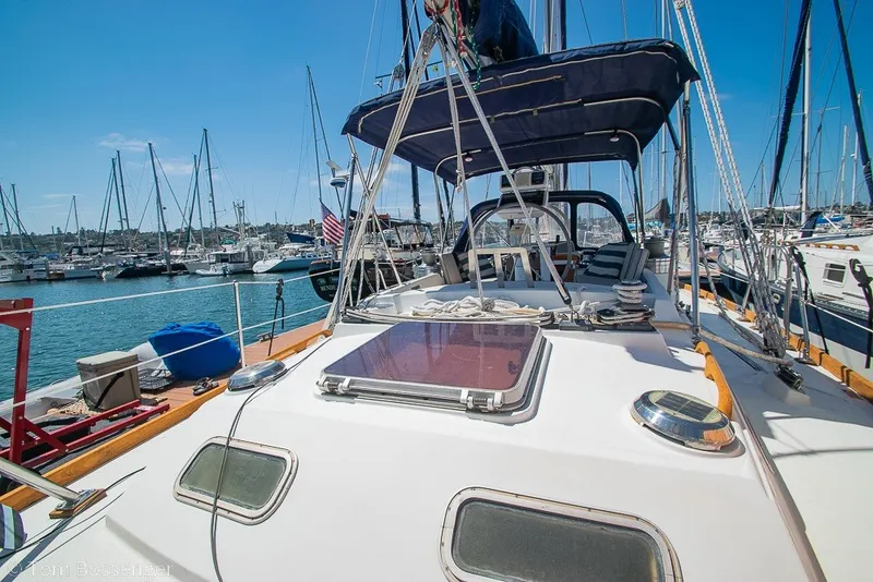 Slide: The Image of 1988 Hylas 44 Center Cockpit sailboat docked in a marina under clear blue skies. - 53