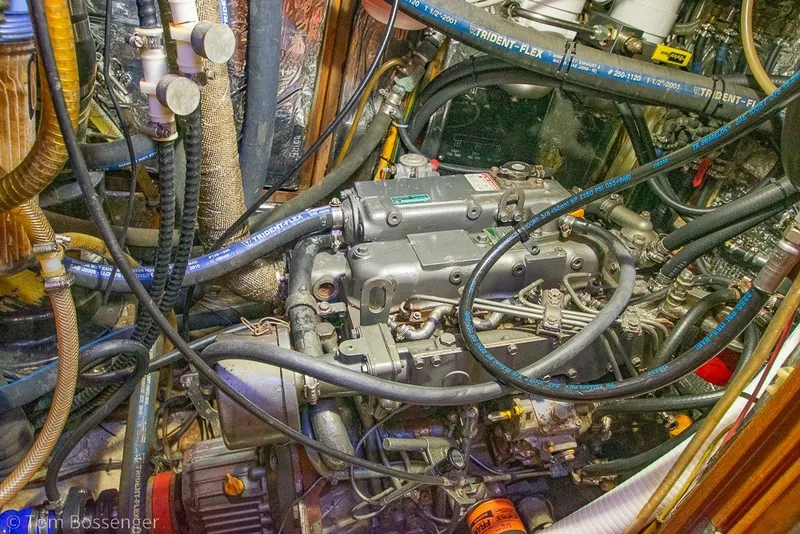 Slide: The Image of Engine compartment of a 1988 Hylas 44 Center Cockpit sailboat with visible hoses and components. - 80