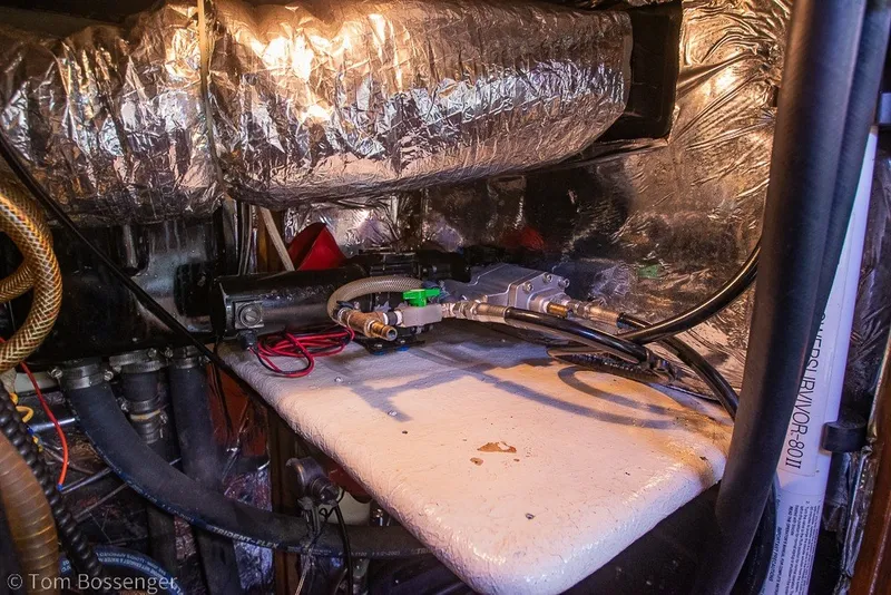 Slide: The Image of Engine compartment of a 1988 Hylas 44 Center Cockpit sailboat, showing mechanical components. - 83