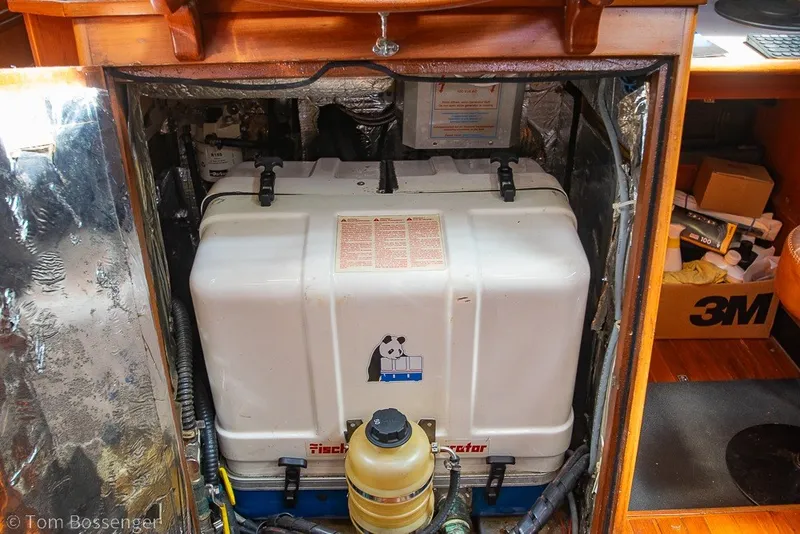 Slide: The Image of Engine compartment of a 1988 Hylas 44 Center Cockpit sailboat, featuring a Fischer Panda generator. - 84