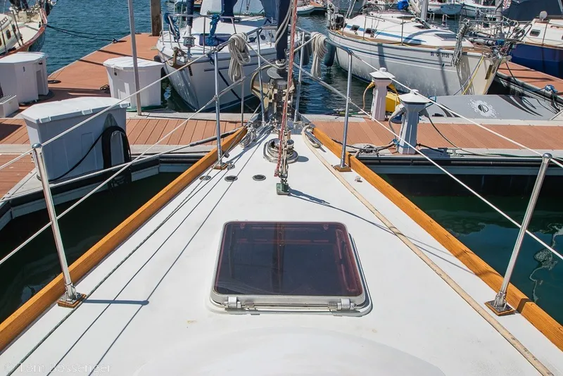 Slide: The Image of Bow view of 1988 Hylas 44 Center Cockpit yacht docked at marina. - 69