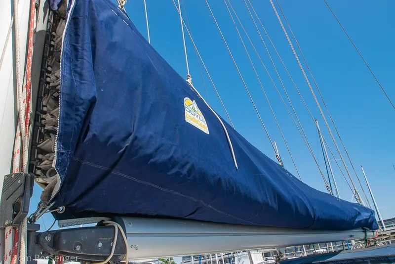 Slide: The Image of 1988 Hylas 44 Center Cockpit sailboat with blue sail cover against clear sky. - 68