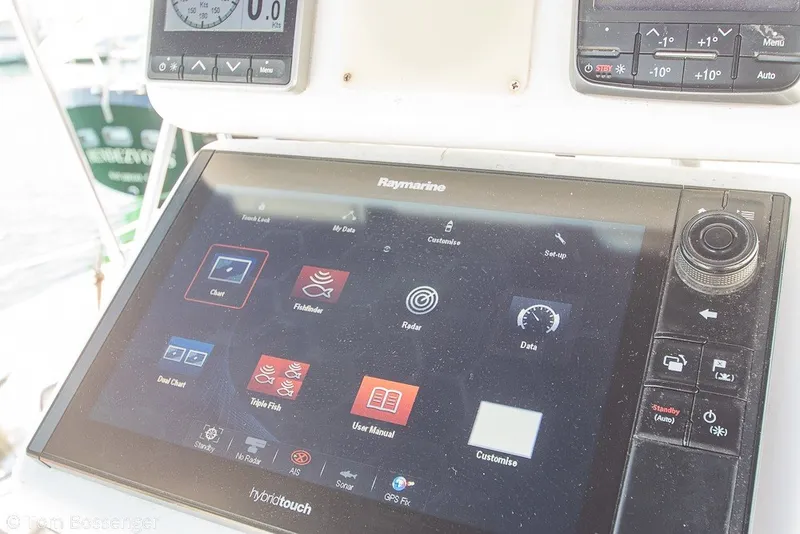 Slide: The Image of Raymarine navigation system on 1988 Hylas 44 Center Cockpit sailboat, displaying charts and data. - 48
