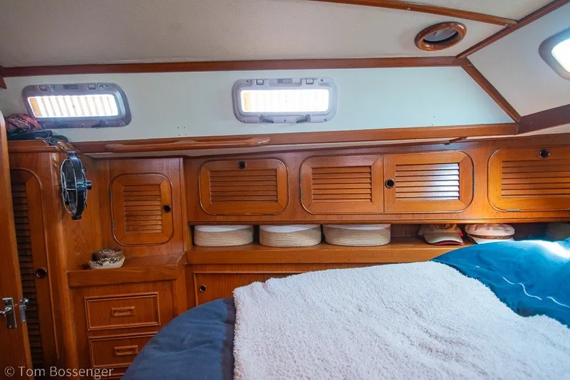 Slide: The Image of Cozy cabin interior of 1988 Hylas 44 Center Cockpit sailboat with wooden cabinetry and portholes. - 26