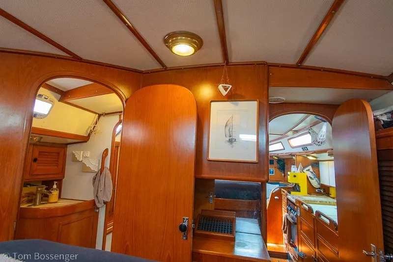 Slide: The Image of Interior of 1988 Hylas 44 Center Cockpit sailboat with wood paneling and nautical decor. - 23