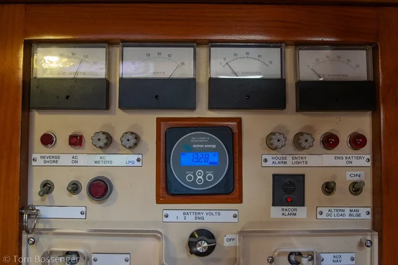 Slide: The Image of Electrical control panel on a 1988 Hylas 44 Center Cockpit yacht, featuring gauges and switches. - 38
