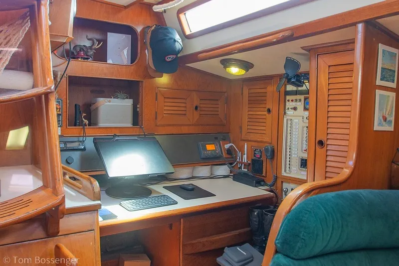Slide: The Image of Interior of 1988 Hylas 44 Center Cockpit with navigation station and wooden cabinetry. - 33