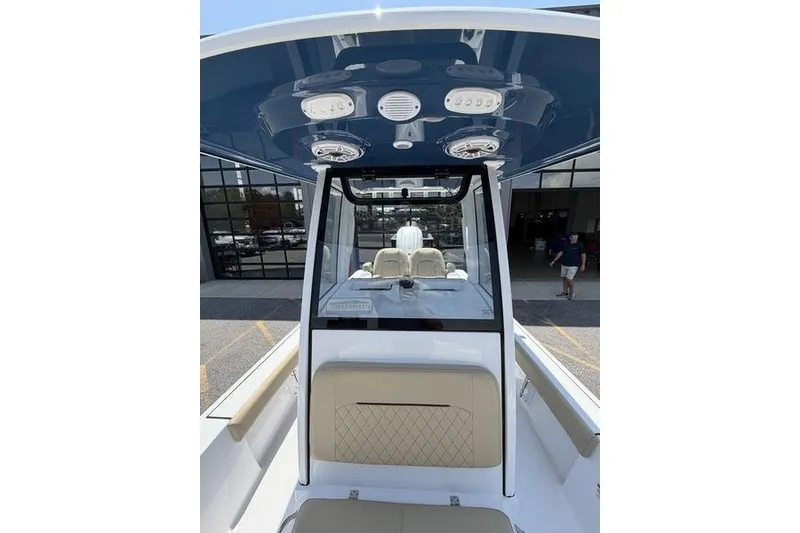 Slide: The Image of 2027 Sportsman Masters 247 Bay Boat interior view with modern seating and overhead console. - 23