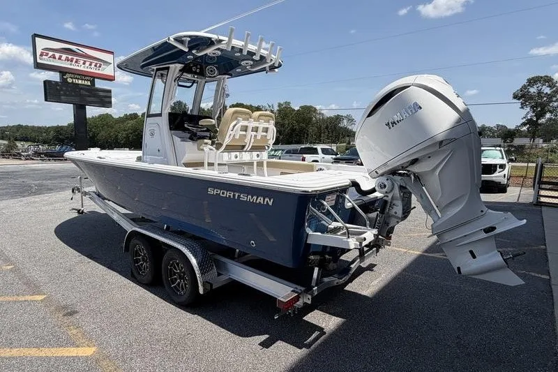 Slide: The Image of 2027 Sportsman Masters 247 Bay Boat on trailer, parked outdoors under clear sky. - 2
