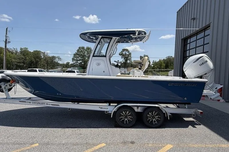 Slide: The Image of 2027 Sportsman Masters 247 Bay Boat on trailer, parked outdoors near a building. - 4