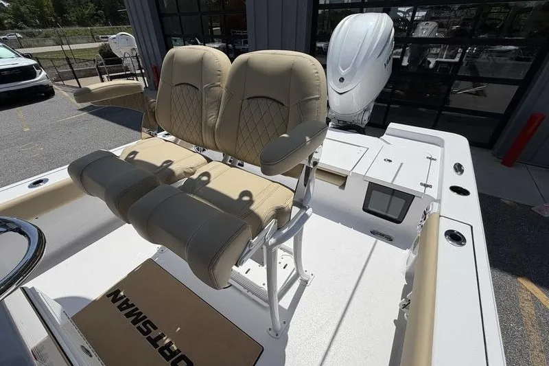 Slide: The Image of 2027 Sportsman Masters 247 Bay Boat with dual beige seats and outboard motor. - 17