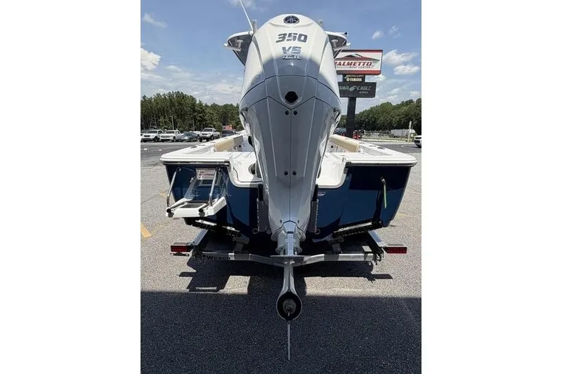Slide: The Image of 2027 Sportsman Masters 247 Bay Boat with powerful 350 V8 engine, parked outdoors. - 5