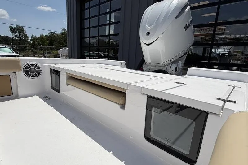 Slide: The Image of 2027 Sportsman Masters 247 Bay Boat interior with Yamaha engine, featuring storage compartments. - 19