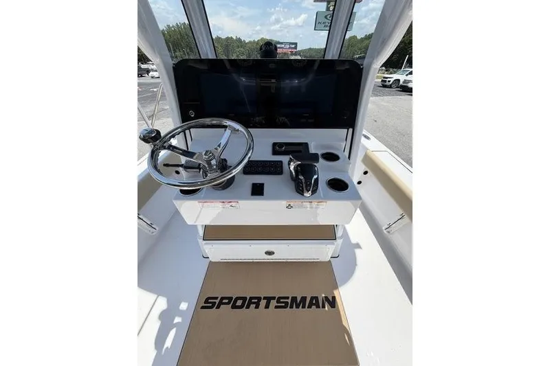 Slide: The Image of 2027 Sportsman Masters 247 Bay Boat helm with steering wheel and controls. - 16