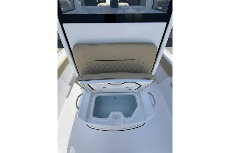 Slide: The Image of 2027 Sportsman Masters 247 Bay Boat with open storage compartment and cushioned seating. - 22