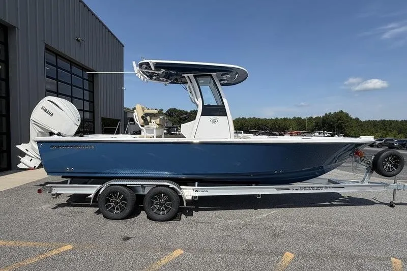 Slide: The Image of 2027 Sportsman Masters 247 Bay Boat on trailer, parked outdoors near a building. - 9