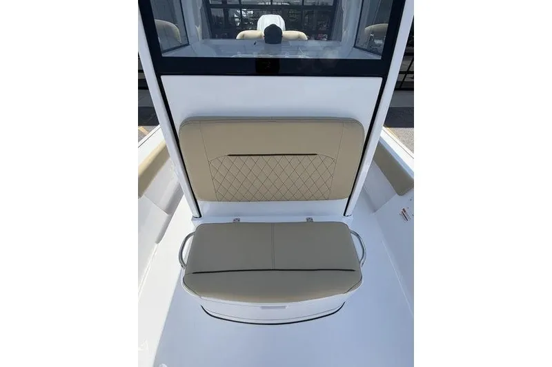 Slide: The Image of 2027 Sportsman Masters 247 Bay Boat interior with beige cushioned seating. - 25