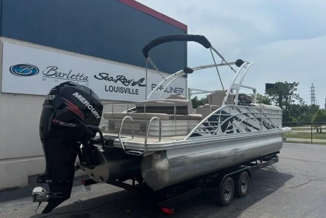 The Image of 2013 Bennington 23GSBA pontoon boat with Mercury outboard motor at dealership. - 1