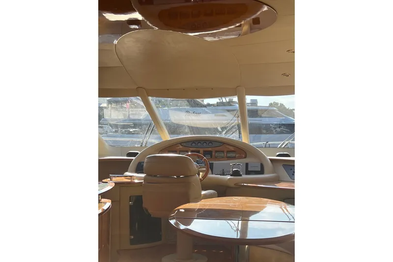 Slide: The Image of Interior view of 2006 Azimut 55E yacht cockpit with luxurious seating and controls. - 16