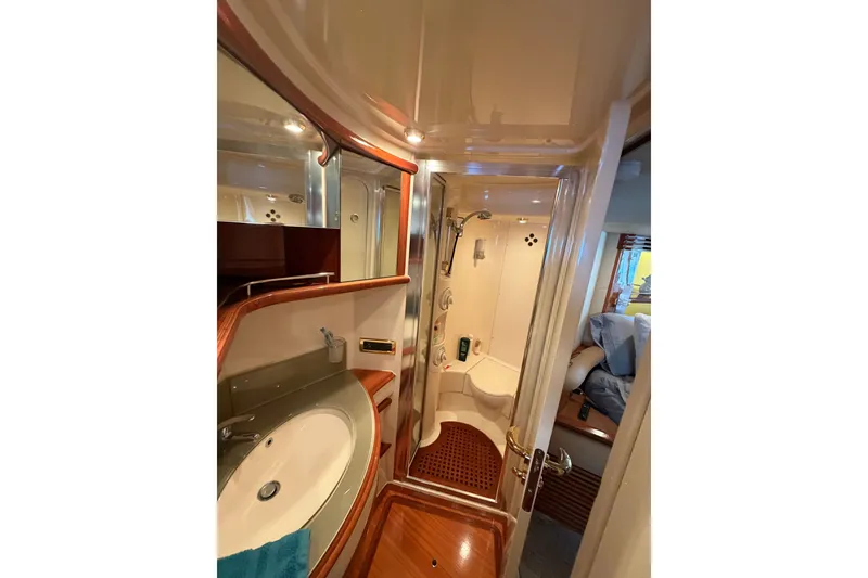 Slide: The Image of Luxurious bathroom interior of 2006 Azimut 55E yacht with elegant wood finishes. - 28