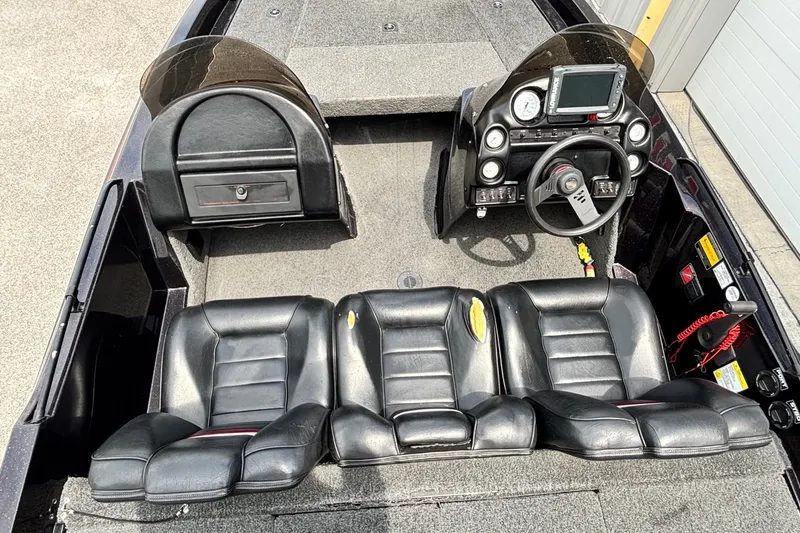Slide: The Image of 1997 Stratos 282 DC boat interior with black leather seats and steering console. - 8