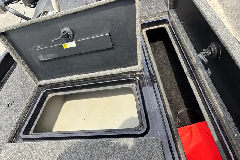 Slide: The Image of 1997 Stratos 282 DC boat storage compartments with open lids, showcasing interior space. - 5