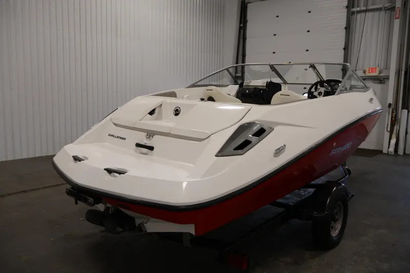 Slide: The Image of 2011 Sea-Doo Challenger 180 boat in a garage, white and red exterior. - 5