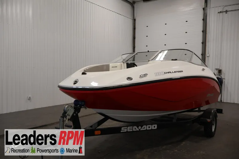Slide: The Image of 2011 Sea-Doo Challenger 180 boat in a showroom, red and white exterior. - 1