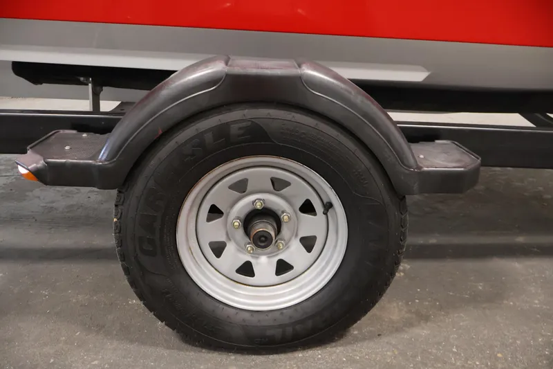 Slide: The Image of 2011 Sea-Doo Challenger 180 trailer wheel with black fender and silver rim. - 35
