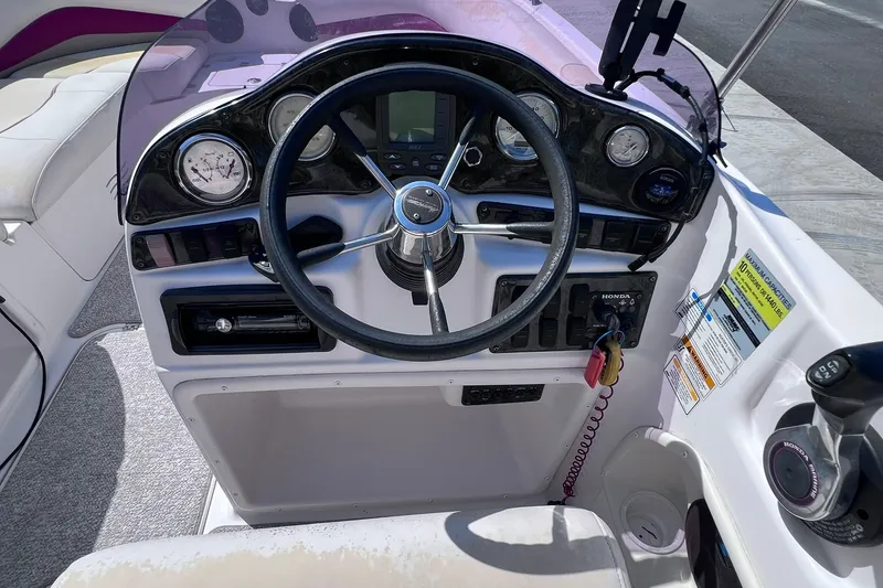 Slide: The Image of 2005 Hurricane FunDeck GS 202 OB boat dashboard with steering wheel and control panel. - 30