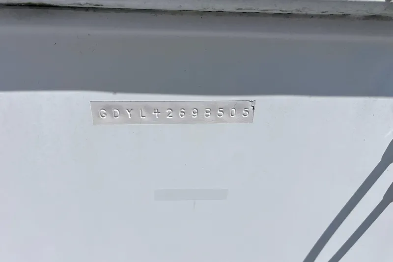 Slide: The Image of 2005 Hurricane FunDeck GS 202 OB hull identification number on white surface. - 43