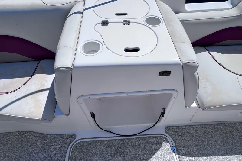 Slide: The Image of 2005 Hurricane FunDeck GS 202 OB boat seating area with cup holders and storage compartment. - 11